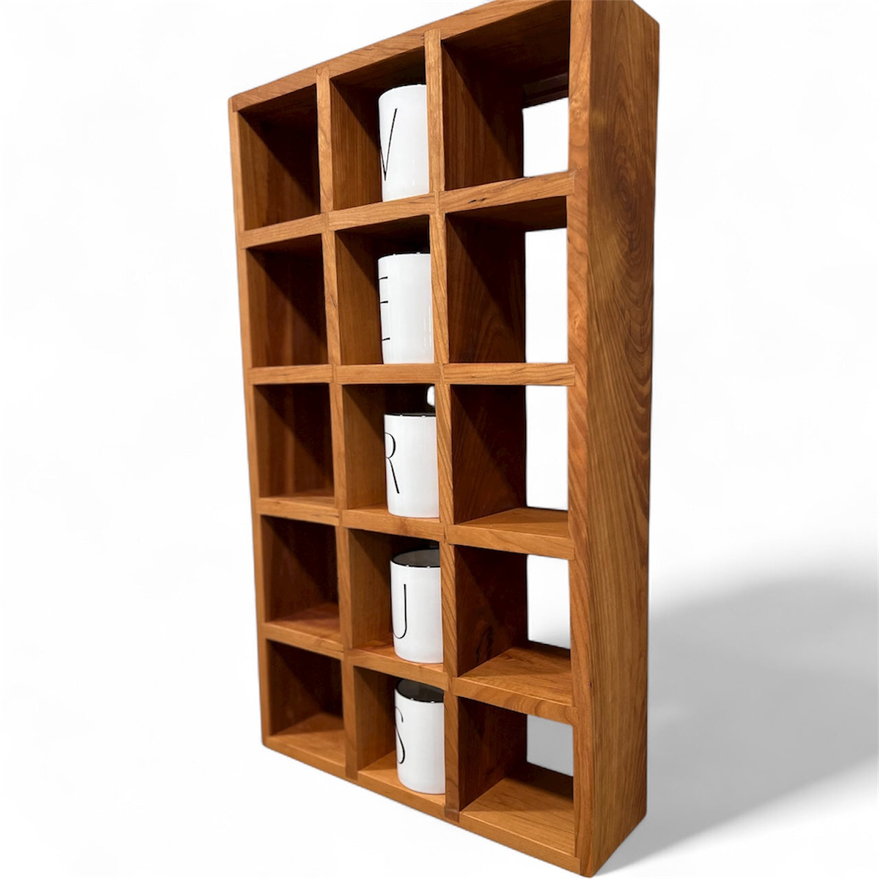 Wooden shelf with square compartments on a white background