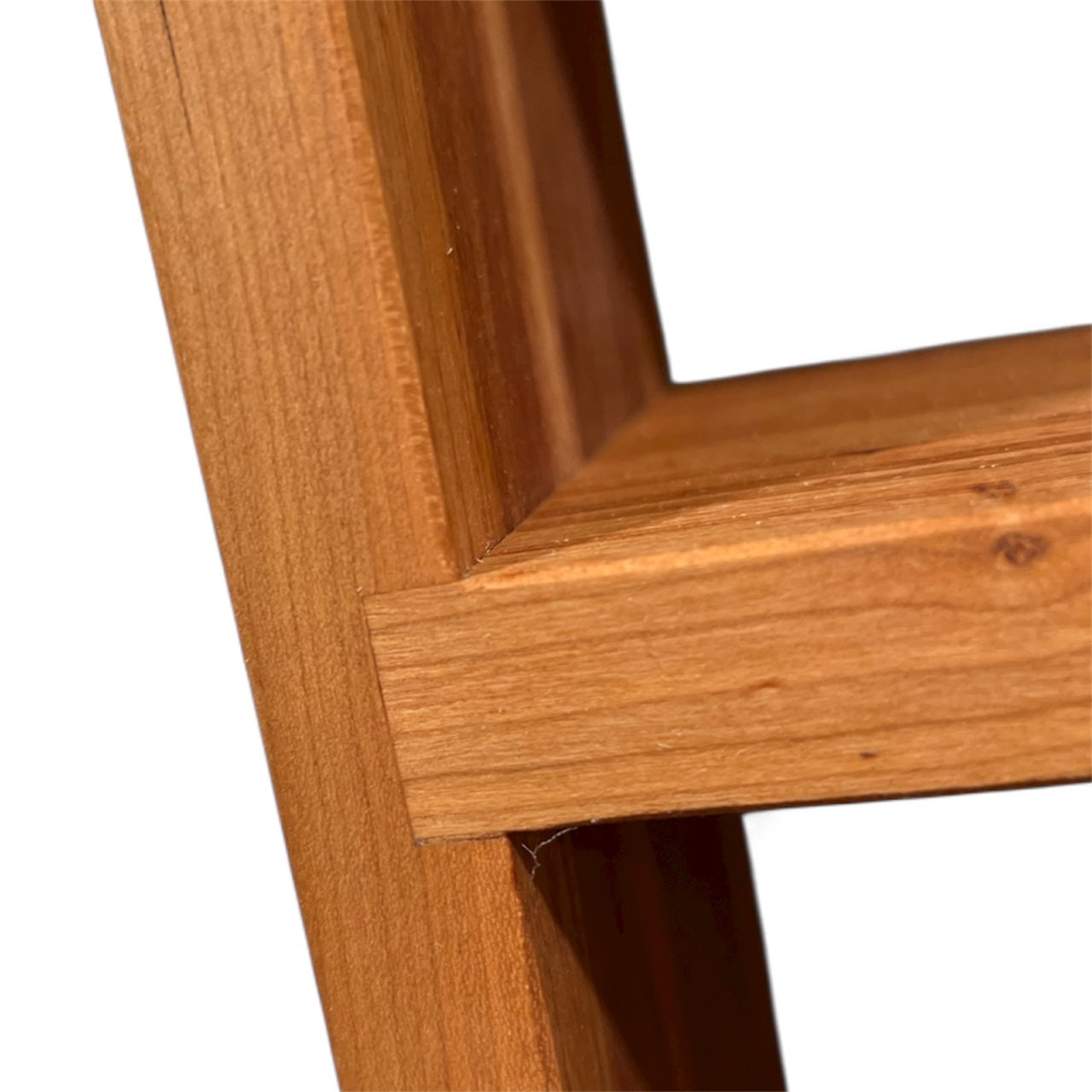 Close-up of a wooden frame corner on a white background