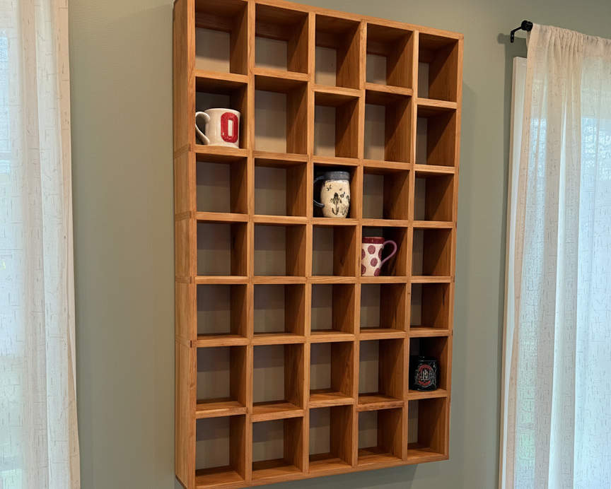 Wooden wall shelf with decorative items against a green wall
