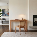 Front view of a minimalist solid oak writing desk showing its slim profile and clean modern design against a neutral background.